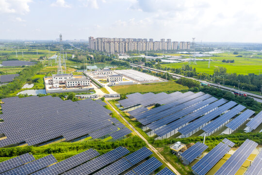 Aerial view of a large solar power plant near the city with rows of photovoltaic panels