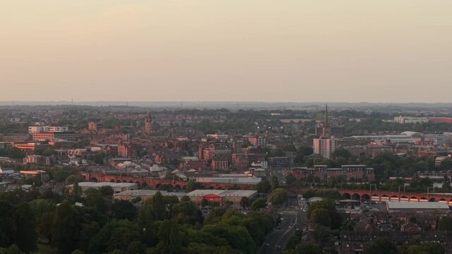 Aerial view of Wakefield, a cathedral city located on the River Calder.in West Yorkshire, England, United Kingdom. Drone POV exploration of city centre and surrounding infrastructure in sunset.