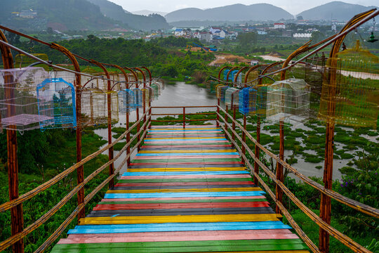 Colorful wooden bridge with bird cages in Lam Dong Province