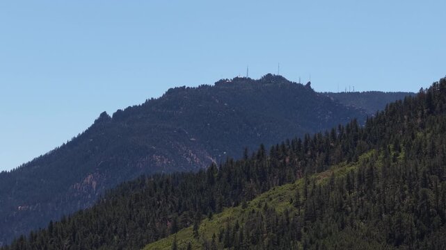 Aerial of dense coniferous forest on rolling mountains in Colorado Springs in summer