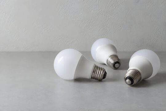 Energy saving LED light bulbs arranged on a neutral tabletop