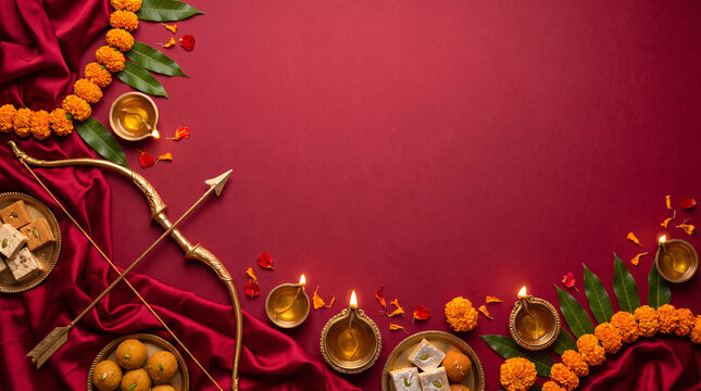 Dussehra festive promotional composition featuring traditional elements like marigold flowers, oil lamps, sweets, and decorative arrows on a red background
