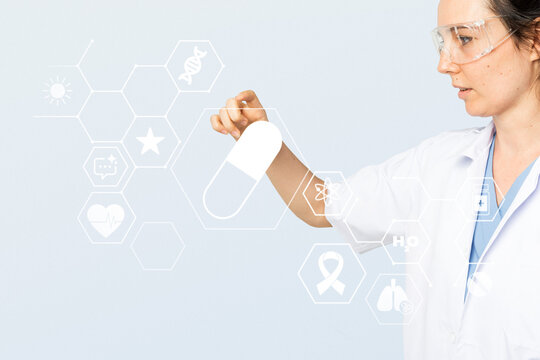Female scientist holding a capsule icon with medical hexagon symbols