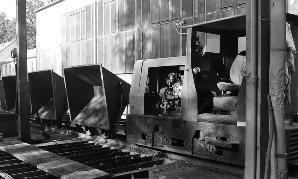 Black and white photo of industrial mining locomotive train.