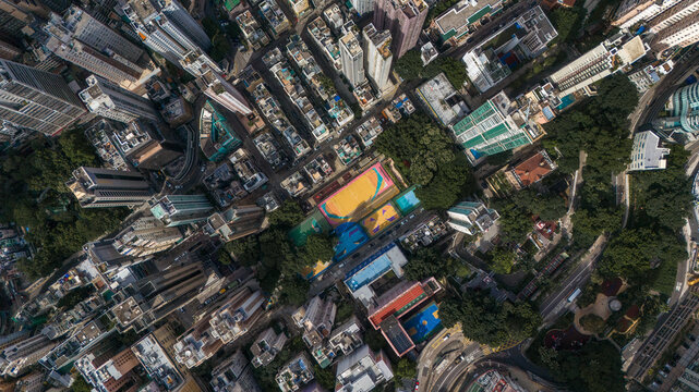 Small colorful sports court tucked between dense buildings in Hong Kong