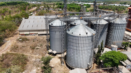 Industrial grain silos and storage at an agricultural feed plant © Salsabila Ariadina