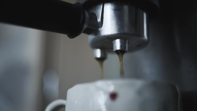 Fresh Espresso Pouring from Coffee Machine into Cup
