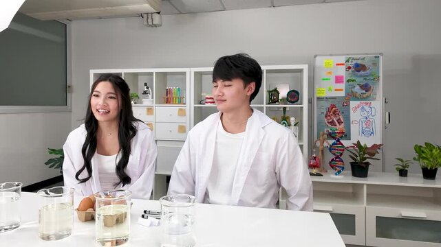 Students in White Lab Coats Conducting Science Experiment in Classroom