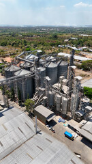 Large metal grain silos and storage buildings in a rural industrial complex in South Kalimantan © Salsabila Ariadina