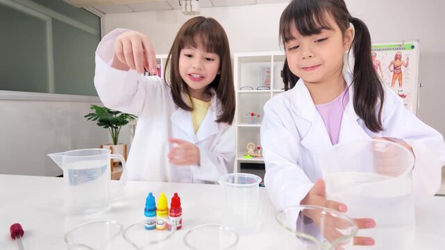 Two Primary School Girls Conducting Science Experiment in Lab