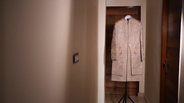 Traditional Indian groom sherwani hanging on a mannequin in Lucknow residence