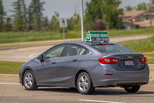 Calgary, Alberta, Canada. September 16, 2026. A gray student driver car drives along a suburban street during a lesson.