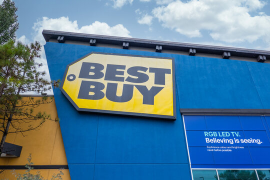 Calgary, AB, Canada - Sept 16, 2026: Exterior view of a Best Buy electronics retail store sign mounted on a blue building facade.