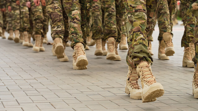 Close-up of soldiers' legs dressed in army camouflage