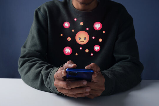 Male Holding Receiving Negative Social Media Feedback and Dislike Icons