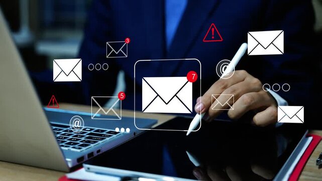 Business person using a tablet and laptop with floating hologram email envelopes animation, alert icons and contact symbols, Business Email Security and Digital Communication Animated on the Screen.