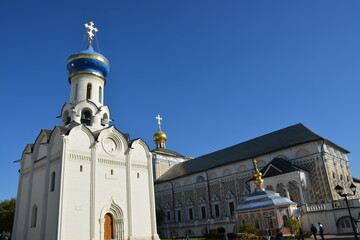 Church and building with domes and crosses in clear blue sky © Alexander