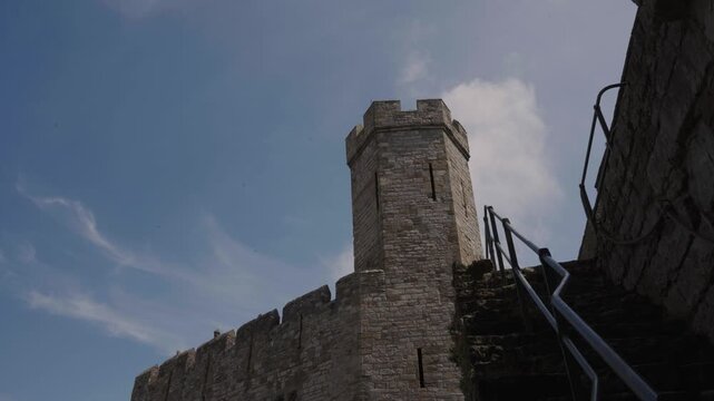 Close-up of medieval architectural patterns at Caernarfon Castle, focusing on geometric tower designs. The composition highlights unique visual characteristics of the castle&rsquo;s construction.