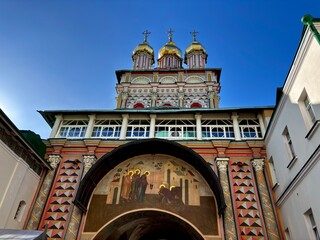 Historic church with colorful architecture and golden domes in sunny weather © Alexander