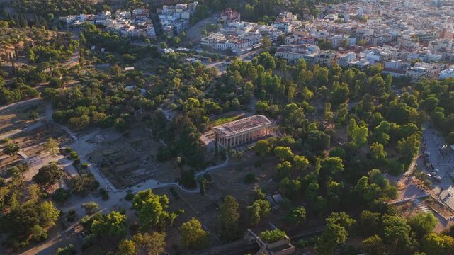 Majestic aerial view of the Temple of Hephaestus, a Doric peripteral temple in Athens, Greece, gracefully positioned atop the Agoraios Kolonos hill in the ancient Agora at sunset