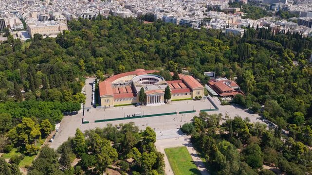 Stunning aerial perspective revealing the neoclassical Zappeion Exhibition Hall and the lush National Garden, with the panoramic cityscape of Athens, Greece, stretching into the distance
