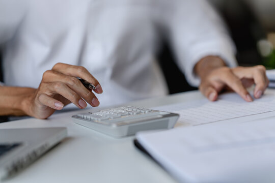 Financial admin reviewing data at worktable in professional office
