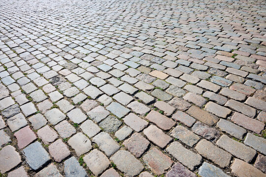 Background created using a close-up of a surface paved with rectangular stones.