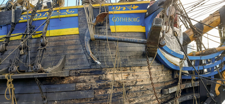 Close-up of the wooden hull and anchor of the replica sailing ship G&ouml;theborg docked in Barcelona - Barcelona, Spain - January 17, 2023