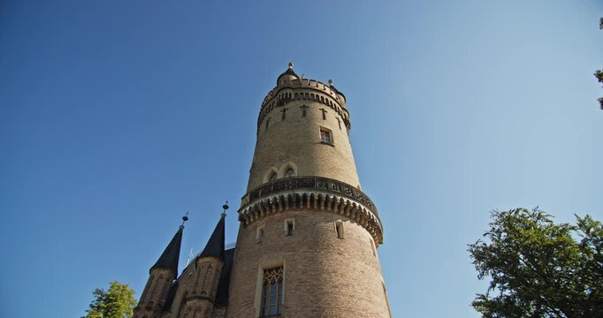 Close low-angle view of the upper gallery and crenellations of Flatow Tower in Babelsberg Park, Potsdam, Germany.