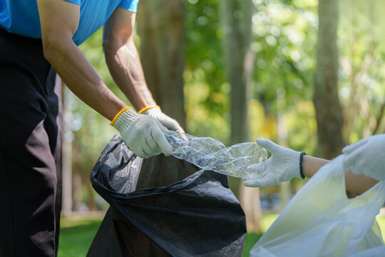 Volunteers collecting plastic waste for park cleanup and recycling