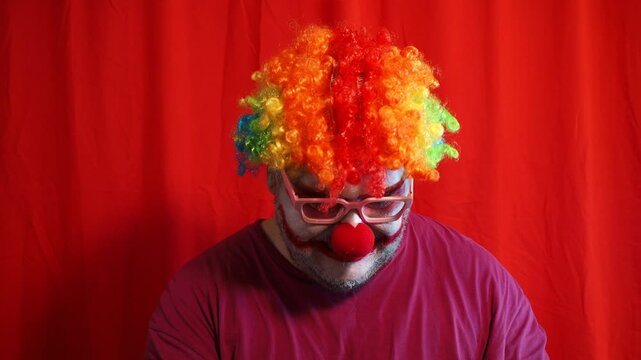 Funny sad clown with white make up face. Carnival mime artist performance.