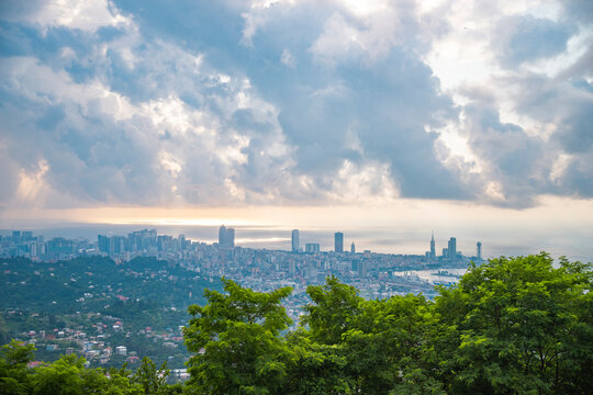 Aerial view of Batumi city skyline under dramatic cloudy sky with copy space