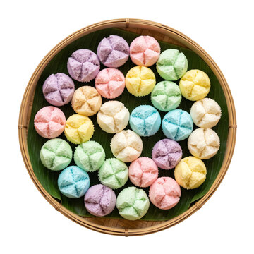 Top view of assorted colorful Thai khanom tuay fu steamed cupcakes on bamboo tray
