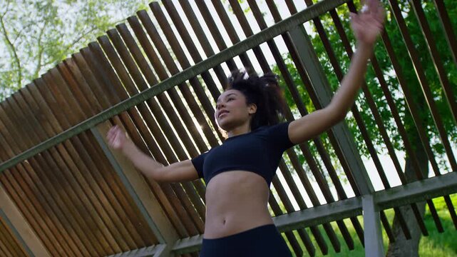 Sporty Woman Completing Park Jumping Jacks