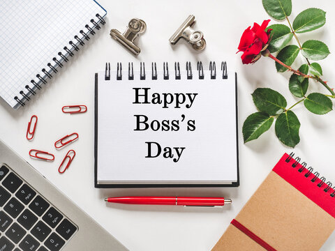 Happy Boss's Day. Desk with a calendar, notebook, and pen. Flat lay workspace. Corporate celebration and leadership appreciation. Symbolizes professional gratitude. Ideal for business content