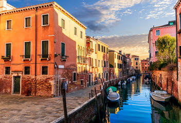 romantic view of a canal in Venice with boats and blue water and beautiful vintage buildings around the cityscape © Yaroslav