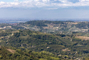 Naklejka premium View of the Langhe-Roero hills and vineyards in Piedmont with the Alps in the background. Italy
