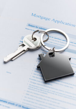Mortgage application form with house keys representing home ownership