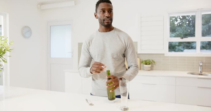 Lifestyle videos indoor of people doing activities at home, pouring beer into glass, man enjoying dr
