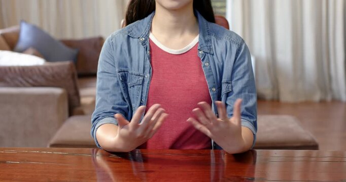 Close up of people talking to the camera, sitting at table, woman gesturing with hands in casual hom