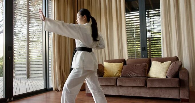 Lifestyle videos indoor of people doing activities at home, practicing martial arts, woman in white