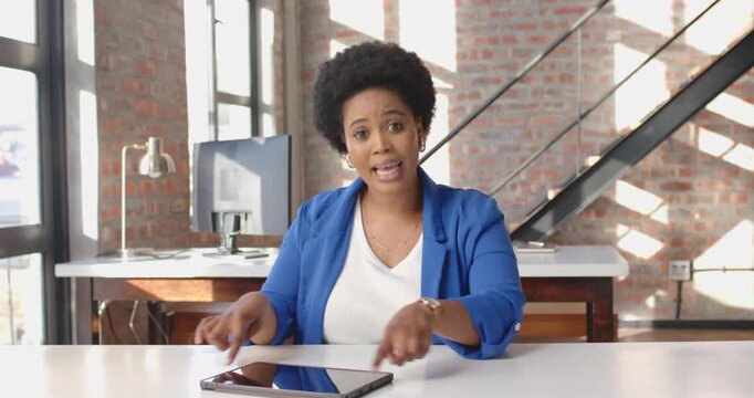Close-up of people talking to the camera, woman in blue blazer speaking in modern office