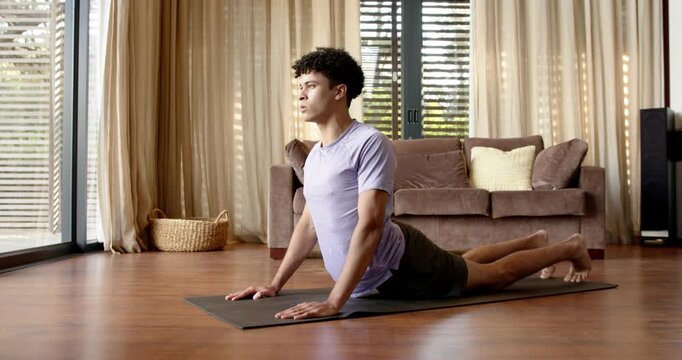 Lifestyle videos indoor of people doing activities at home, practicing yoga, man in downward dog pos