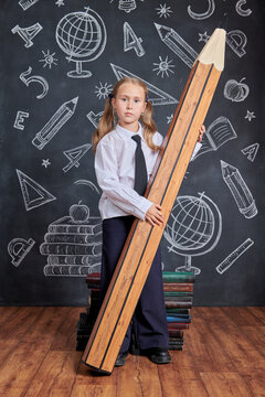 Schoolgirl Holds Giant Pencil
