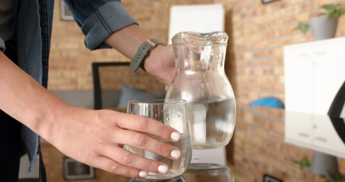 Lifestyle videos indoor of people doing activities at office, smiling woman holding glass, enjoying