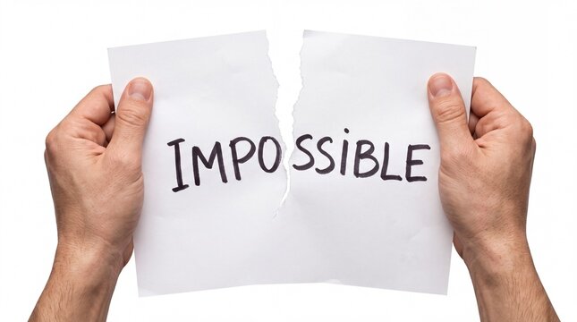 Hands tearing a white sheet of paper with the word impossible written on white background