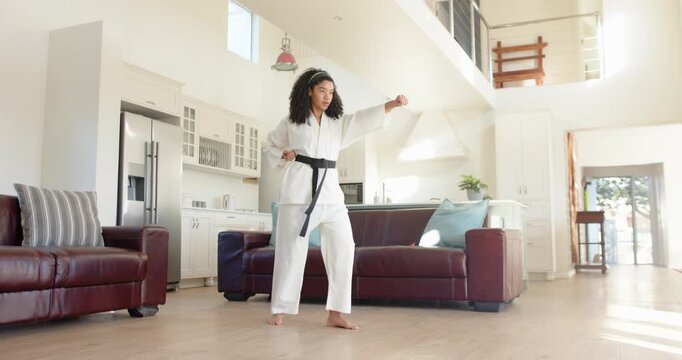 Lifestyle videos indoor of people doing activities at home, practicing martial arts, woman in karate