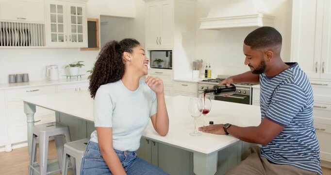 Lifestyle videos indoor of people doing activities at home, pouring red wine, man serving drink to w
