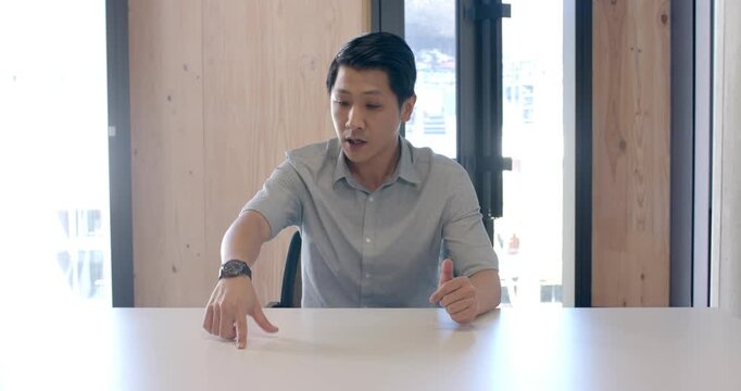 Close up of people talking to the camera, businessman in office pointing at table while explaining s