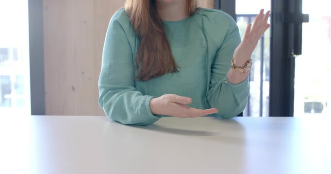 Close up of people talking to the camera, clapping hands, woman in blue shirt sitting at desk in off